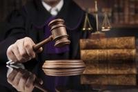 Judge wielding gavel in courtroom