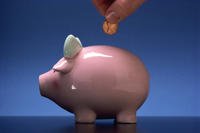 Putting money in a piggy bank.
