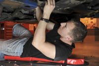 Auto engine repair on creeper.